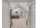 Bright bathroom featuring tiled floors, a vanity with wooden cabinets, and a walk-in closet beyond at 2006 Sandy Pond Ln, Waxhaw, NC 28173