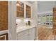 Convenient butler's pantry with white cabinets, granite countertop, and glass-door display cabinets at 2006 Sandy Pond Ln, Waxhaw, NC 28173