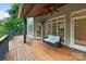 Relaxing outdoor deck with comfortable seating, wood ceiling, and views of the surrounding wooded backyard at 2006 Sandy Pond Ln, Waxhaw, NC 28173