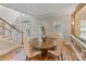 Cozy dining area with hardwood floors, round table, and stylish chairs near the staircase at 2006 Sandy Pond Ln, Waxhaw, NC 28173