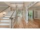 Bright foyer boasting a grand staircase, wood floors, and an open layout leading to various living spaces at 2006 Sandy Pond Ln, Waxhaw, NC 28173