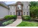 Beautiful home exterior with stone accents, manicured landscaping, and inviting walkway at 2006 Sandy Pond Ln, Waxhaw, NC 28173