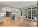 Gourmet kitchen with an island, stainless appliances, white cabinets, and natural light with views of the backyard at 2006 Sandy Pond Ln, Waxhaw, NC 28173