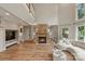 Cozy living room features a stone fireplace, hardwood floors, and seamless access to the kitchen at 2006 Sandy Pond Ln, Waxhaw, NC 28173