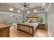 Spacious main bedroom featuring hardwood floors, tray ceilings, recessed lighting, and sitting area at 2006 Sandy Pond Ln, Waxhaw, NC 28173