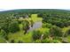 An aerial view of a house with a pond and green fields that stretch far into the distance at 2006 Sandy Pond Ln, Waxhaw, NC 28173