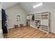 Spacious walk-in closet with custom shelving, hardwood floors, a window, and accent seating at 2006 Sandy Pond Ln, Waxhaw, NC 28173