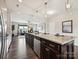 Large kitchen island featuring granite countertops, stainless steel appliances, and open to the living area at 2017 New Hope Branch Way, Belmont, NC 28012