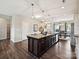 Spacious kitchen island with granite countertops, stainless steel appliances, and views of the dining area at 2017 New Hope Branch Way, Belmont, NC 28012