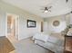Comfortable bedroom featuring a ceiling fan and adjacent bathroom with glass shower at 2017 New Hope Branch Way, Belmont, NC 28012