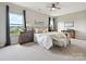 Serene main bedroom with large windows, a ceiling fan, and neutral decor at 2017 New Hope Branch Way, Belmont, NC 28012