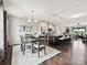 Open concept living and dining area with hardwood floors, modern lighting, and stylish decor at 2017 New Hope Branch Way, Belmont, NC 28012