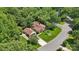 Aerial view of a house with lush landscaping, mature trees, and a detached garage at 2234 Hamilton Mill Rd, Charlotte, NC 28270