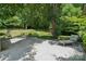 Spacious backyard features a large patio with outdoor seating and a swing surrounded by mature trees at 2234 Hamilton Mill Rd, Charlotte, NC 28270
