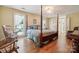 Cozy bedroom with hardwood floors, 4 poster bed, bright window, and accent chair at 2234 Hamilton Mill Rd, Charlotte, NC 28270