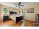Bright bedroom featuring hardwood floors, a large bed, and art filled walls at 2234 Hamilton Mill Rd, Charlotte, NC 28270