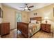 Bedroom with hardwood floors, a ceiling fan, and a bed with a wooden frame and a quilted blanket at 2234 Hamilton Mill Rd, Charlotte, NC 28270