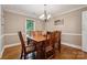 Cozy dining room featuring hardwood floors, a chandelier, and a wooden dining set for six at 2234 Hamilton Mill Rd, Charlotte, NC 28270