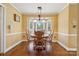 Bright dining room with bay window and hardwood floors with a wooden table that seats six at 2234 Hamilton Mill Rd, Charlotte, NC 28270