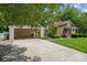 Charming brick home featuring a spacious driveway, a two-car garage and well-maintained landscaping at 2234 Hamilton Mill Rd, Charlotte, NC 28270