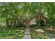 Charming brick home featuring a well-maintained lawn and mature trees providing shade and curb appeal at 2234 Hamilton Mill Rd, Charlotte, NC 28270