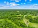 An aerial view of a large lot with mature trees, farmland, and a home on the property at 2309 Potter S Rd, Waxhaw, NC 28173