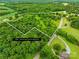 Aerial view of property's ~21 acres lot, featuring a mix of trees and clear land at 2309 Potter S Rd, Waxhaw, NC 28173