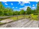 Back deck perfect for outdoor entertaining, offers a table and chairs, and overlooks the backyard at 2309 Potter S Rd, Waxhaw, NC 28173