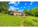 Backyard view of a two-story brick home with wooden deck at 2309 Potter S Rd, Waxhaw, NC 28173