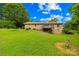 A large lawn with a brick home and a raised wooden deck at 2309 Potter S Rd, Waxhaw, NC 28173