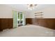 Bedroom featuring wood paneling, carpet and built-in shelves at 2309 Potter S Rd, Waxhaw, NC 28173