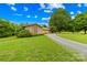 Gravel driveway leads to a house with brick and stone exterior at 2309 Potter S Rd, Waxhaw, NC 28173