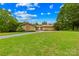 Lovely front yard with mature trees leads to a brick and stone house at 2309 Potter S Rd, Waxhaw, NC 28173
