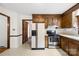 Functional kitchen with stainless steel appliances, wood cabinets, and bright linoleum floors at 2309 Potter S Rd, Waxhaw, NC 28173