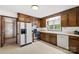 Well-lit kitchen with stainless steel appliances, wood cabinets, and ample counter space at 2309 Potter S Rd, Waxhaw, NC 28173