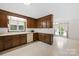 Charming kitchen featuring wood cabinets, linoleum floors, and lots of natural light at 2309 Potter S Rd, Waxhaw, NC 28173