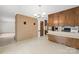 Traditional eat-in kitchen with brick accent wall and wood cabinets at 2309 Potter S Rd, Waxhaw, NC 28173