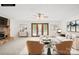 A staged living room with a fireplace, white sofa, and chairs at 2309 Potter S Rd, Waxhaw, NC 28173