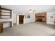 Open floor plan with a stone fireplace and built-in shelving offering a cozy and inviting space at 2309 Potter S Rd, Waxhaw, NC 28173