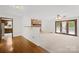 Open living room with stone fireplace, wood floors, and sliding doors to the outdoor deck at 2309 Potter S Rd, Waxhaw, NC 28173
