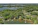 Stunning aerial view of a lakefront home with mature trees, a private dock, and approximate lot lines at 2563 Brawley School Rd, Mooresville, NC 28117