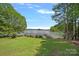 Picturesque waterfront view featuring a lush lawn and private dock access at 2563 Brawley School Rd, Mooresville, NC 28117
