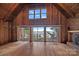 Bright living room with vaulted ceilings, fireplace, and expansive lake views at 2563 Brawley School Rd, Mooresville, NC 28117