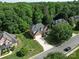 Aerial view of a home in a neighborhood with lush trees, manicured lawns and curved streets at 2608 Golden Bell Dr, Gastonia, NC 28056