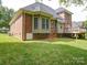 The backyard has a large grassy area, a deck, and mature trees at 2608 Golden Bell Dr, Gastonia, NC 28056