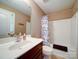 Well-lit bathroom featuring a vanity, mirror, and a shower-tub combination at 2608 Golden Bell Dr, Gastonia, NC 28056