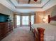 Comfortable main bedroom featuring a tray ceiling, a ceiling fan, and large windows at 2608 Golden Bell Dr, Gastonia, NC 28056