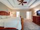 Comfortable main bedroom featuring a tray ceiling, a ceiling fan, and a flat screen tv at 2608 Golden Bell Dr, Gastonia, NC 28056