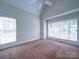 Bright bedroom featuring two windows and a ceiling fan at 2608 Golden Bell Dr, Gastonia, NC 28056