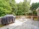 Cozy wooden deck featuring a grill, dining table and outdoor patio heater at 2608 Golden Bell Dr, Gastonia, NC 28056